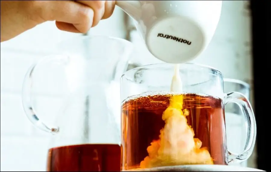 pouring milk in tea
